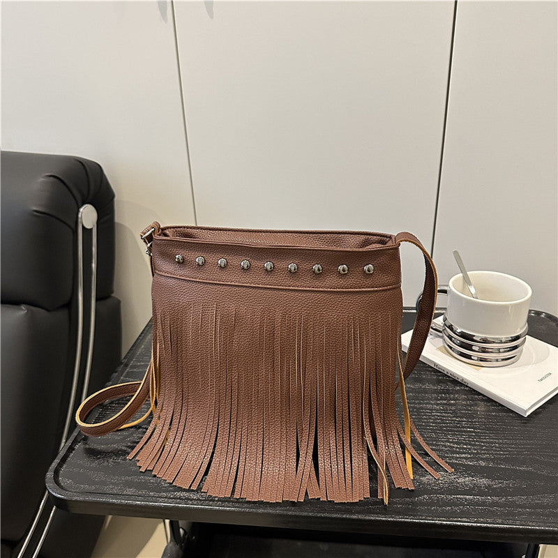Ladies shoulder bag with fringes and studs