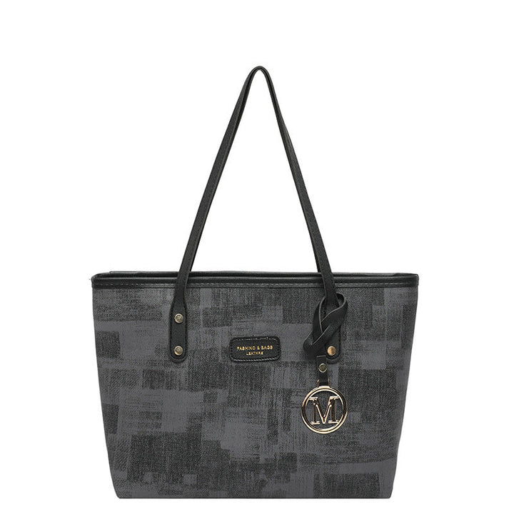 Women's stylish tote bag with textured design and elegant details