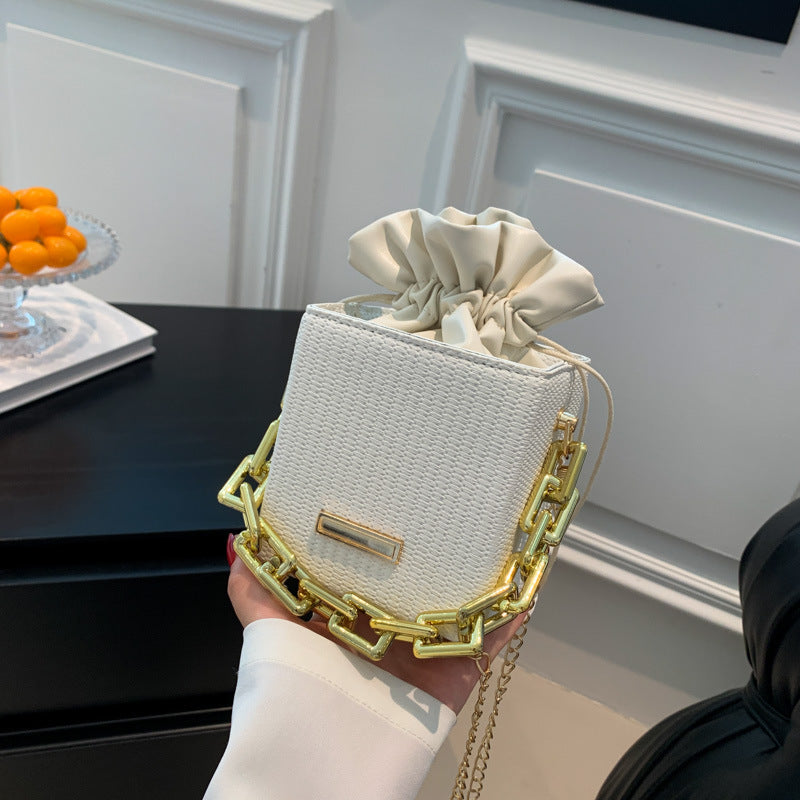 Women's mini handbag with unique chain embellishment and classic drawstring