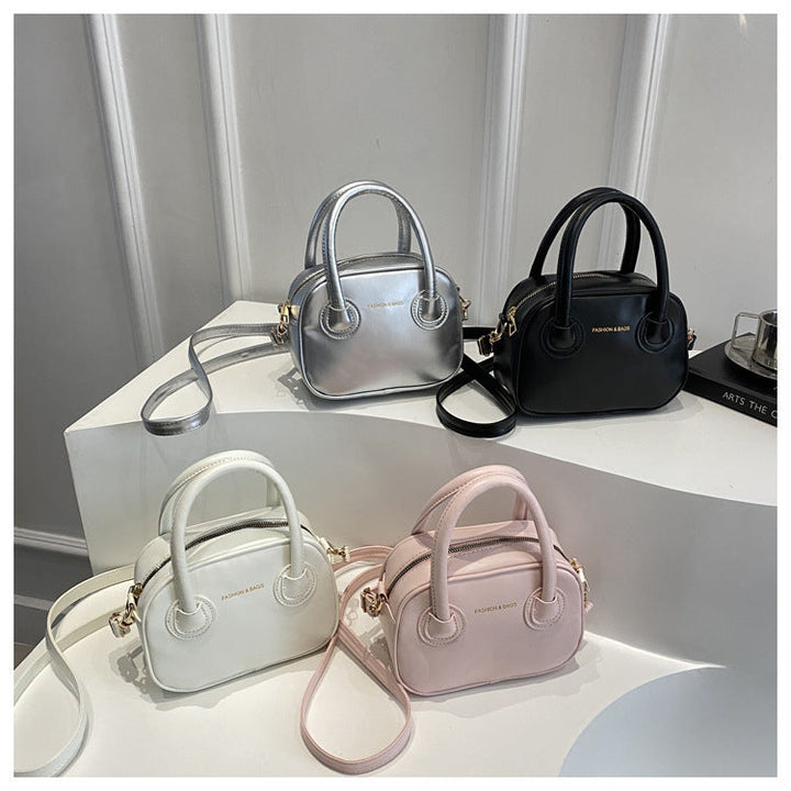 Ladies fashionable handbag with elegant pull handles and removable shoulder strap