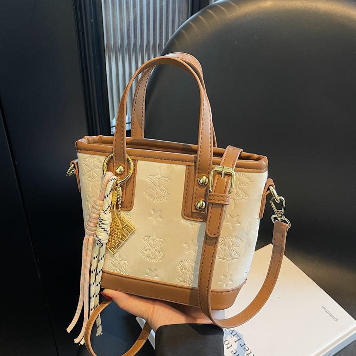 Ladies mini bag in playful design with decorative charm