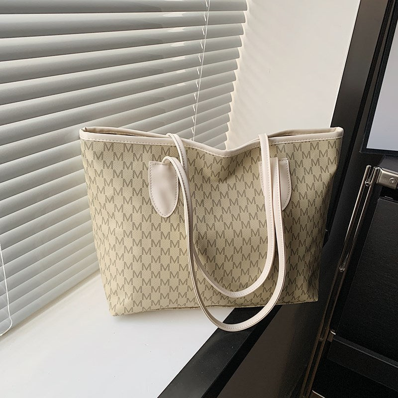 Women's tote bag made of high-quality, durable material with elegant monogram
