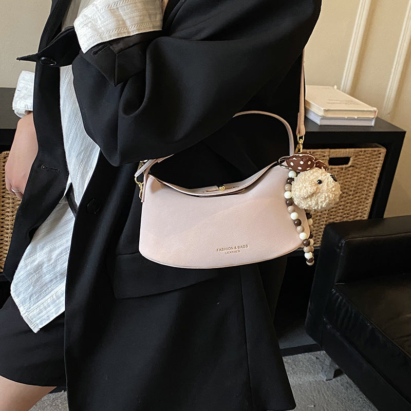 Women's shoulder bag with decorative pendant