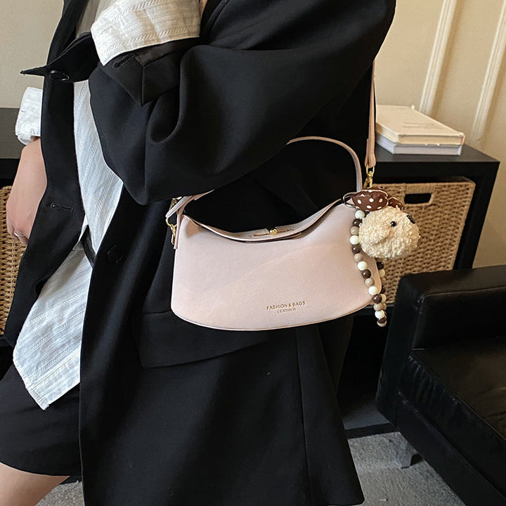 Women's shoulder bag with decorative pendant