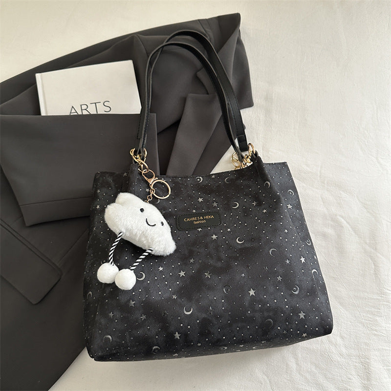 Women’s stylish tote bag with playful pendant