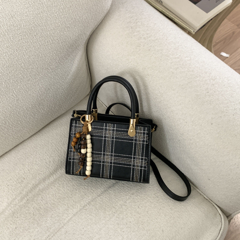 Women's mini handbag with elegant structure and golden accents