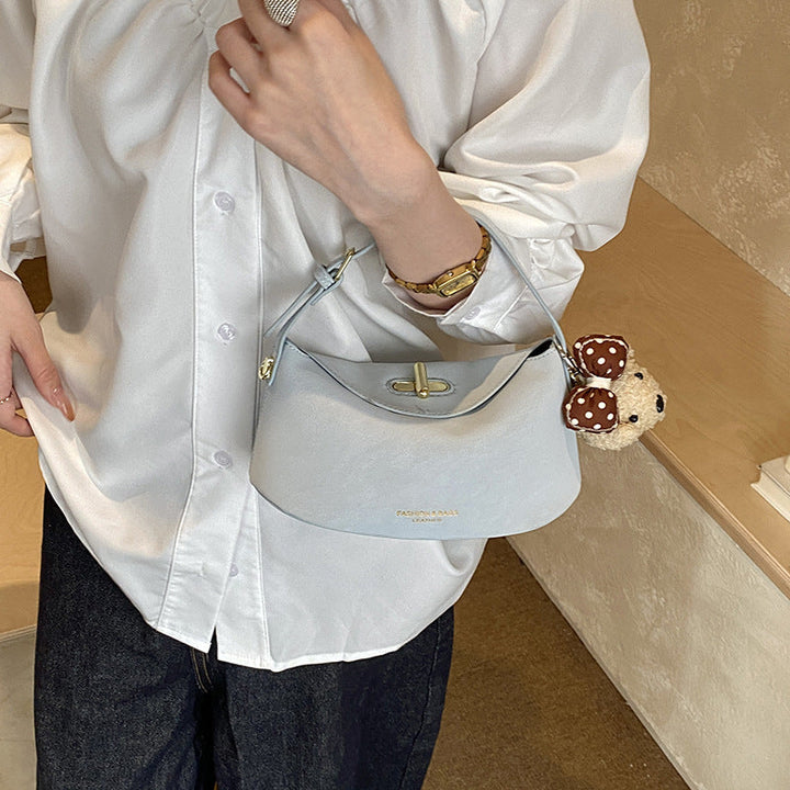 Women's shoulder bag with decorative pendant
