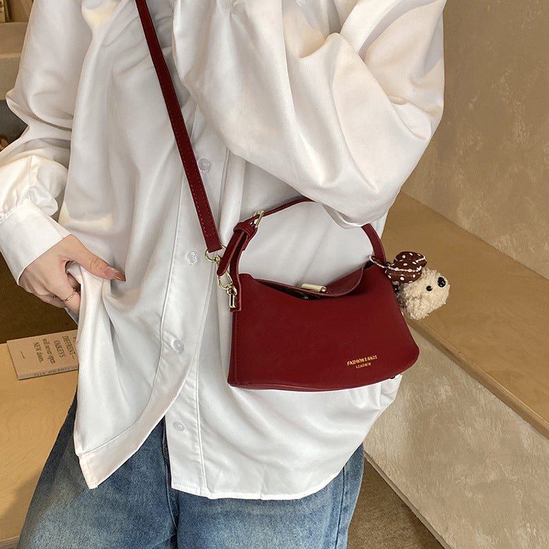 Women's shoulder bag with decorative pendant