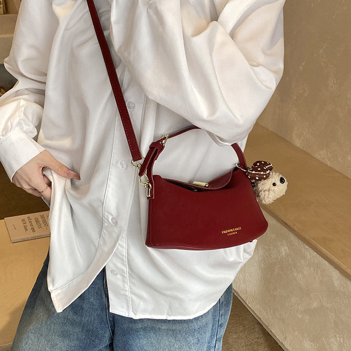Women's shoulder bag with decorative pendant