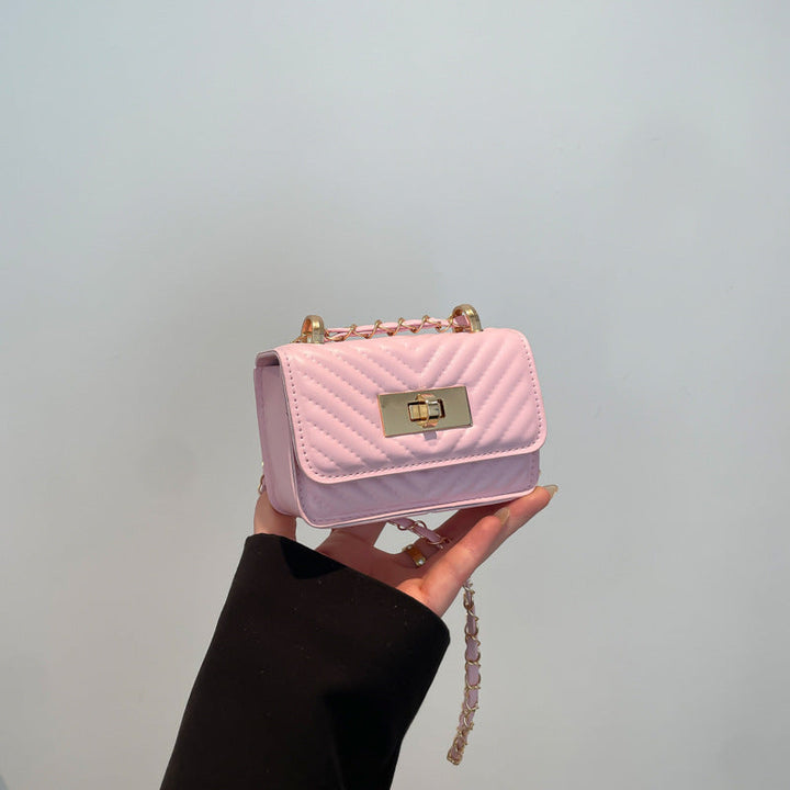 Women’s mini handbag with quilted design and golden clasp