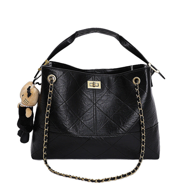 Women's shoulder bag with elegant chain accent and cute pendant