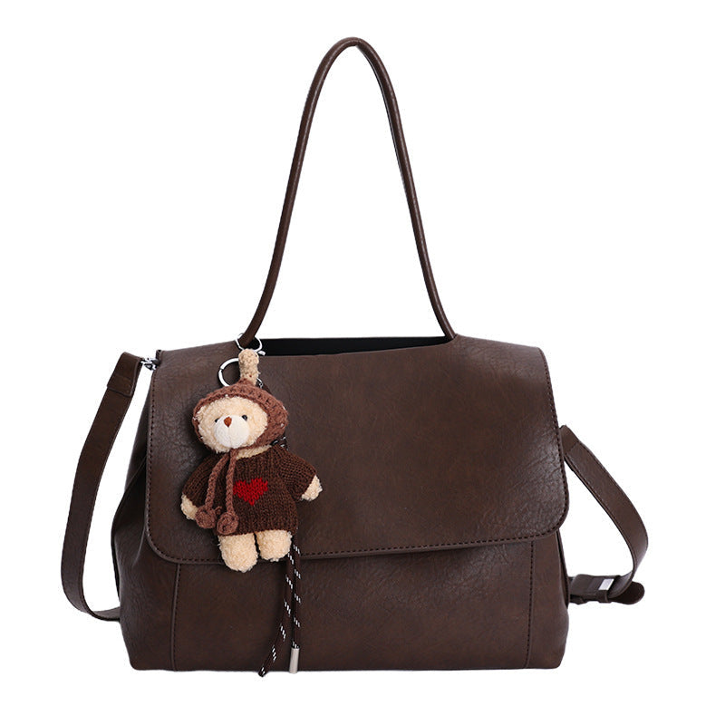 Women's fashionable shoulder bag with charming pendant
