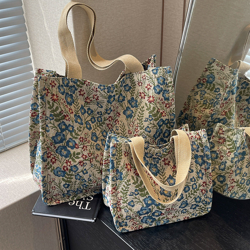 Women's tote bag with floral embroidery design and sturdy handles
