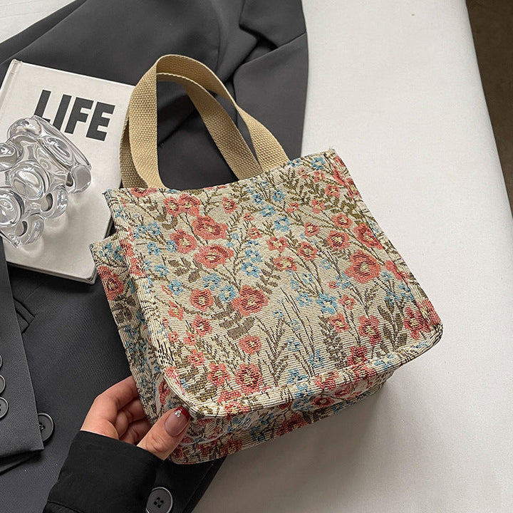 Women's tote bag with floral embroidery design and sturdy handles