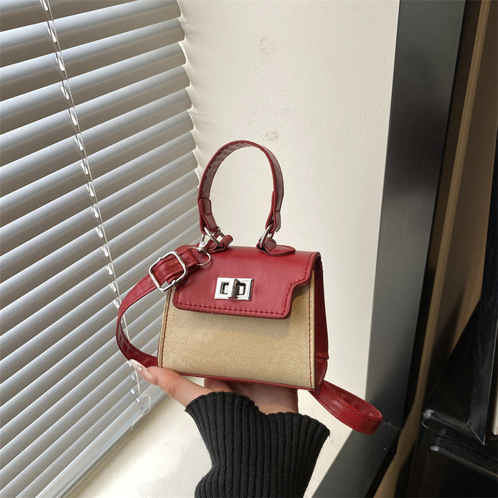 Ladies mini handbag with luxurious leather look and practical carrying handles