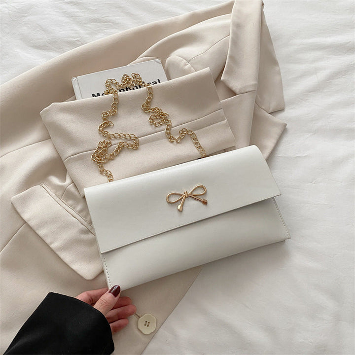 Women's elegant clutch in minimalist design with golden accents
