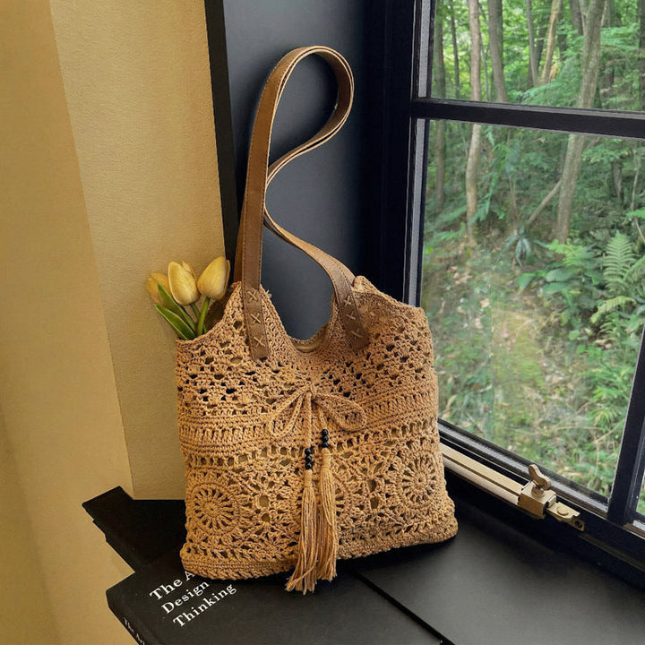 Ladies' crochet shoulder bag with playful fringes and decorative details