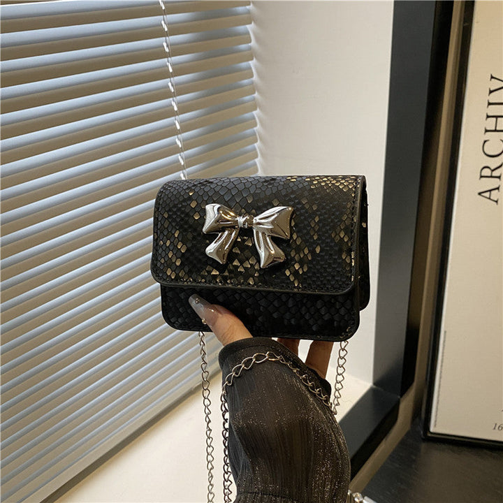 Women's clutch with playful bow design