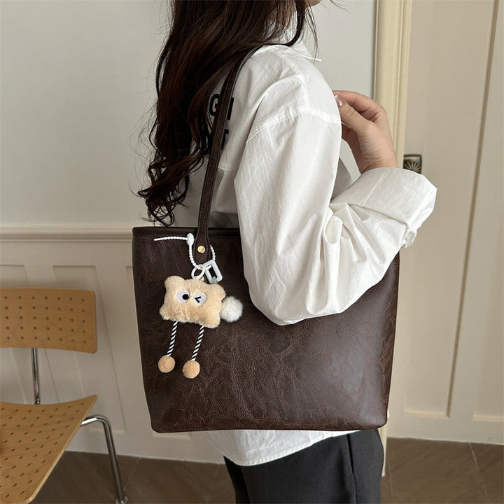 Women's classic tote bag with charming plush toy pendant