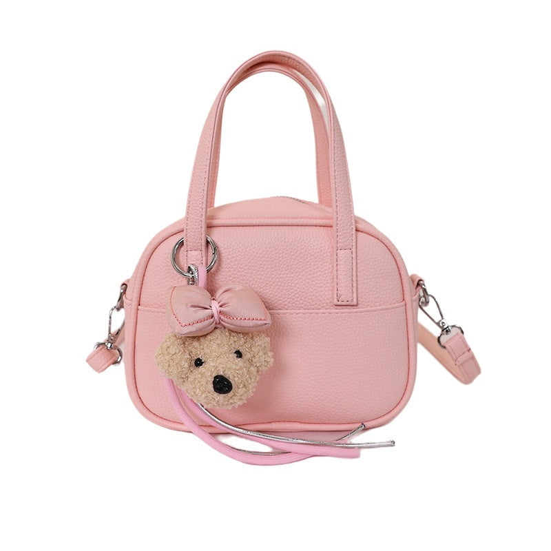 Women's mini handbag with playful animal charm