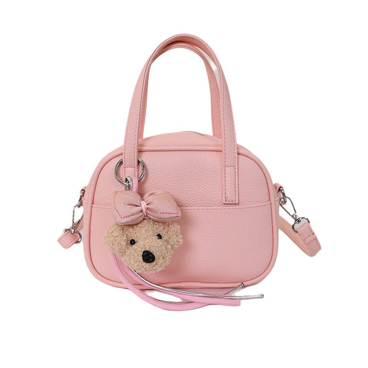 Women's mini handbag with playful animal charm