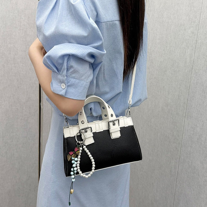 Women's mini handbag with playful pendant and elegant design