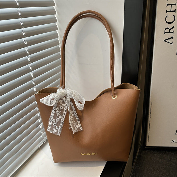 Women’s tote bag made of high-quality synthetic leather with playful bow detail