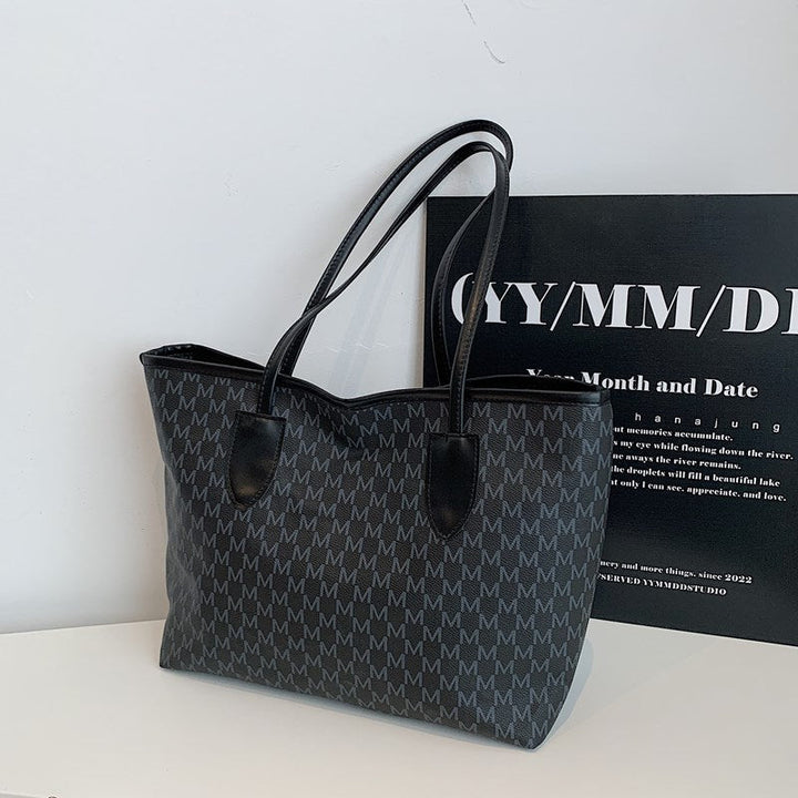 Women's tote bag made of high-quality, durable material with elegant monogram