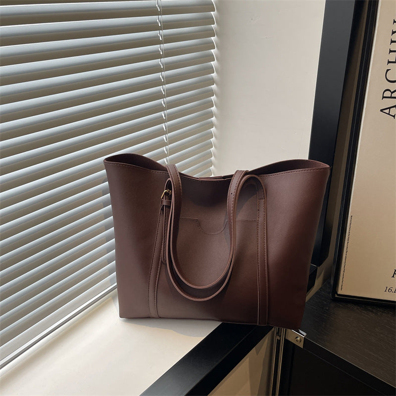 Women's tote bag made of structured synthetic leather with stylish detail