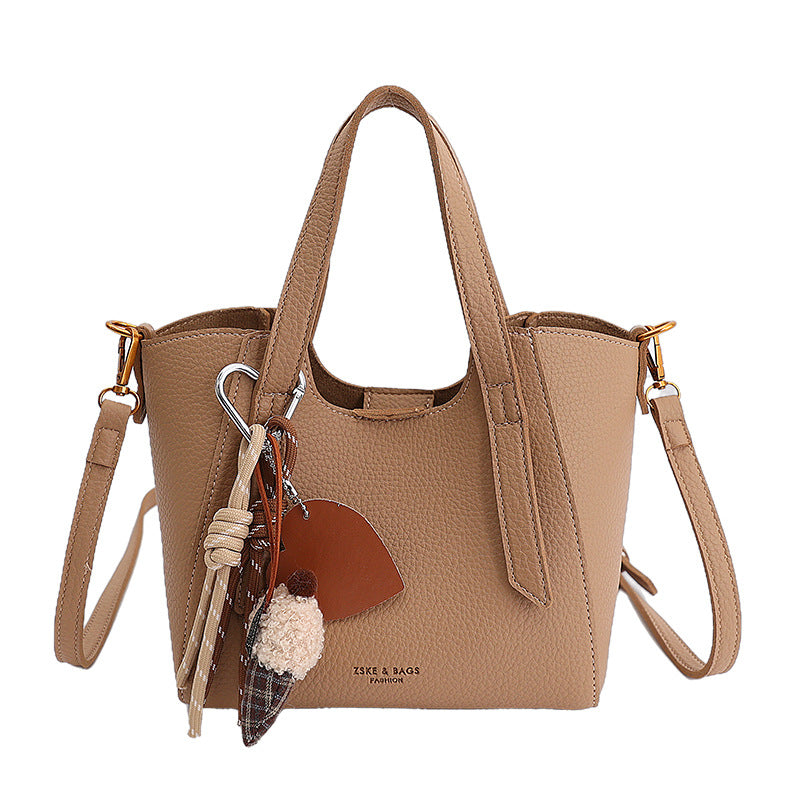 Women's mini handbag in an elegant design with charming pendant