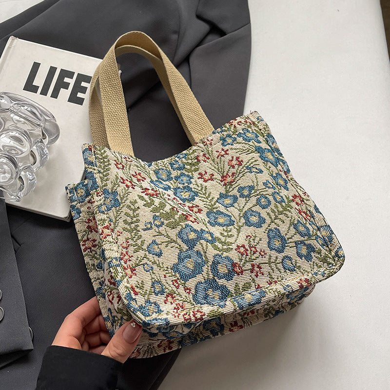 Women's tote bag with floral embroidery design and sturdy handles