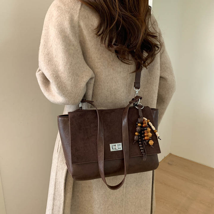 Women's elegant shoulder bag made of high-quality faux leather with playful charm
