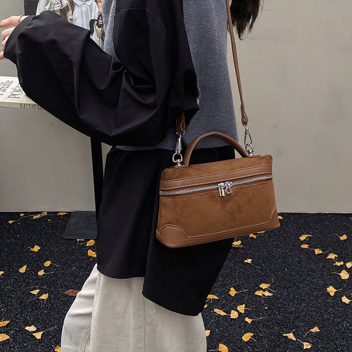 Women's shoulder bag made of soft suede leather with practical compartments