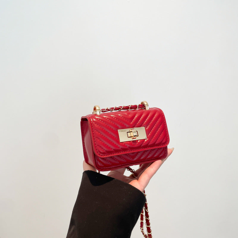 Women’s mini handbag with quilted design and golden clasp