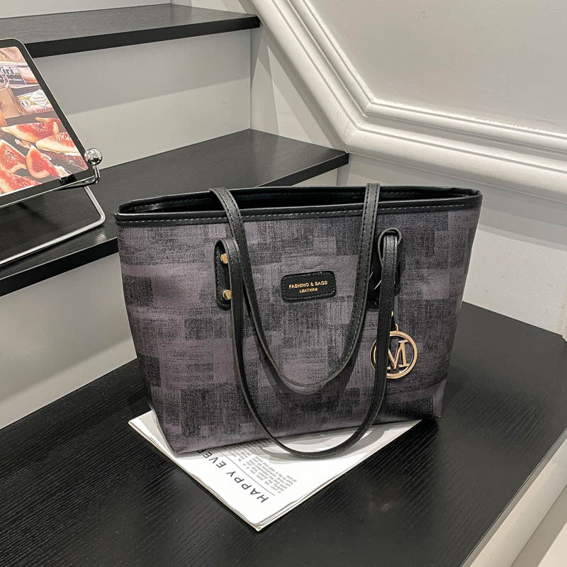 Women's stylish tote bag with textured design and elegant details