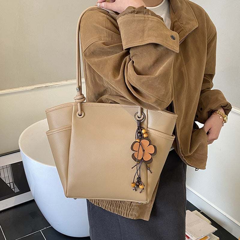 Women's practical shoulder bag with charming appliqués
