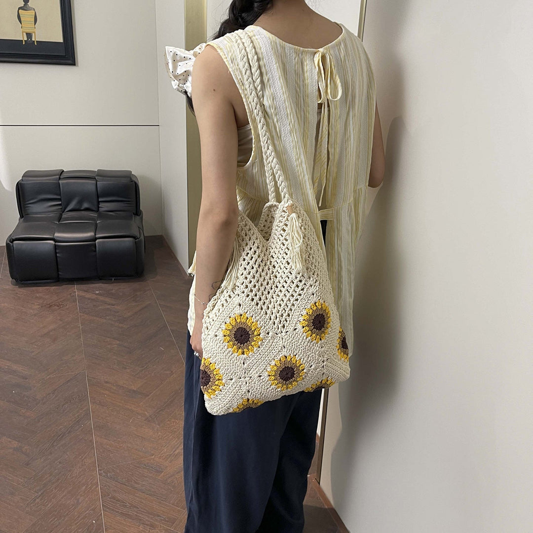 Ladies crocheted shoulder bag with playful sunflower appliqués
