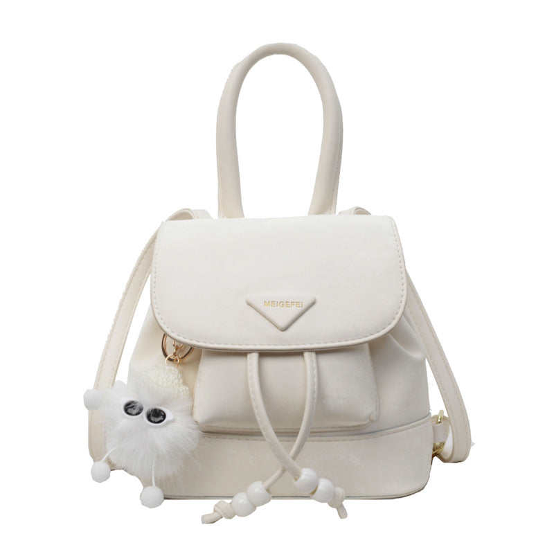 Women's mini backpack with playful design and plush pendant