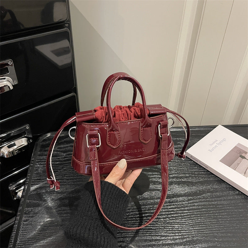 Women's mini bag with playful drawstring and shiny finish