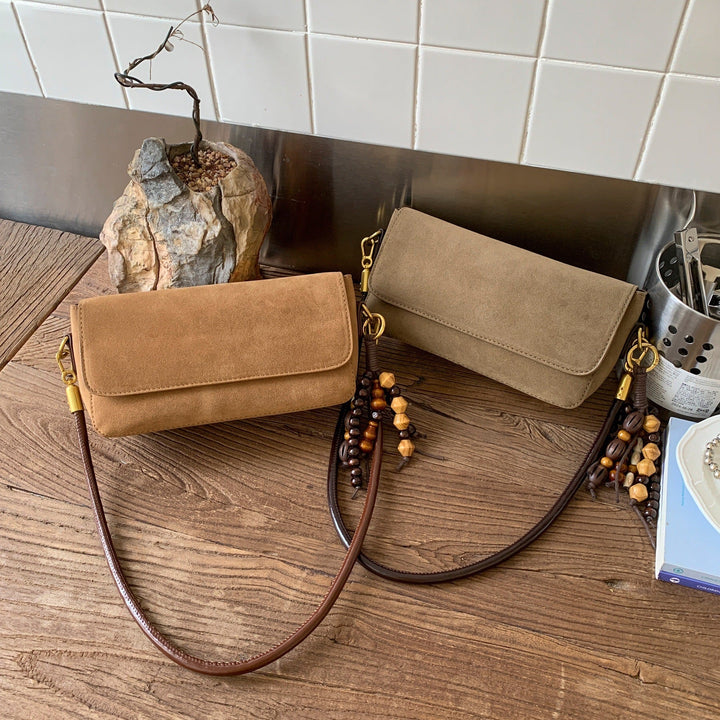 Women's shoulder bag made of fine suede leather with practical shoulder strap