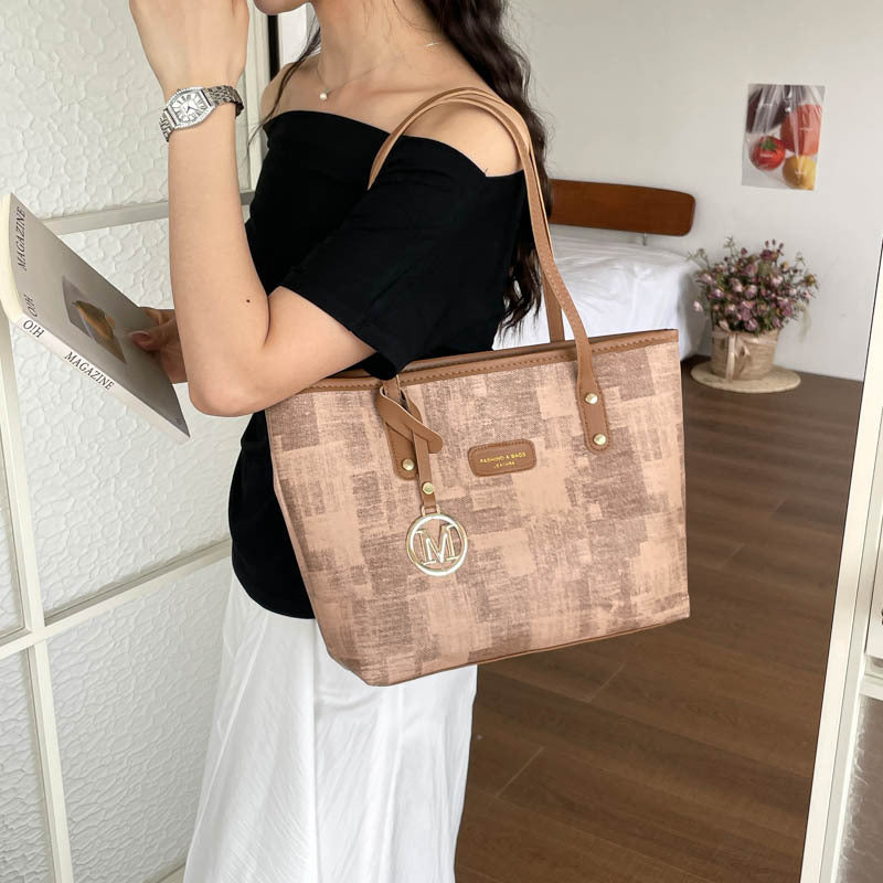 Women's stylish tote bag with textured design and elegant details