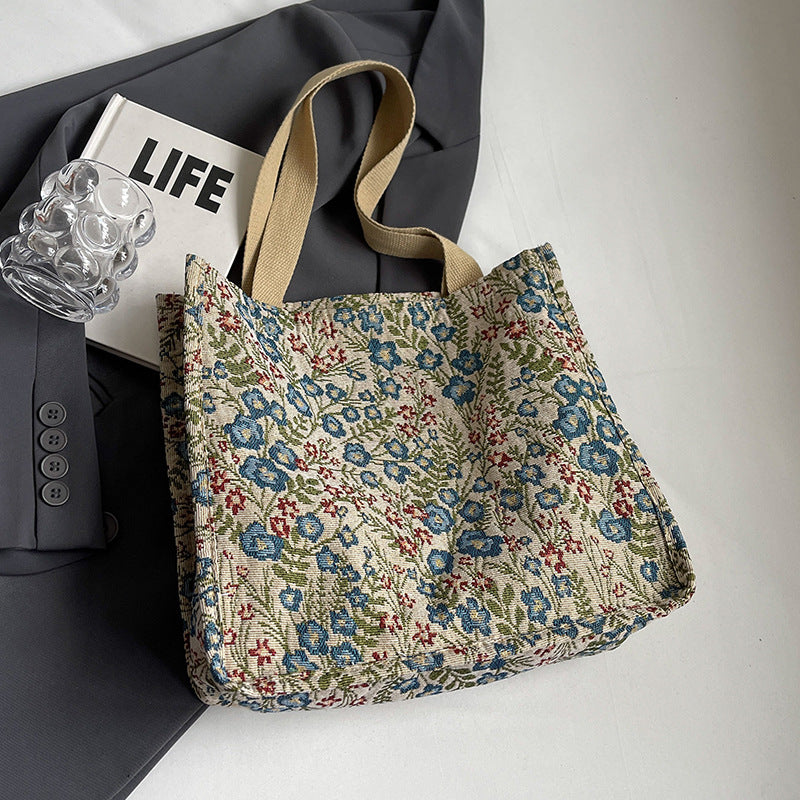 Women's tote bag with floral embroidery design and sturdy handles