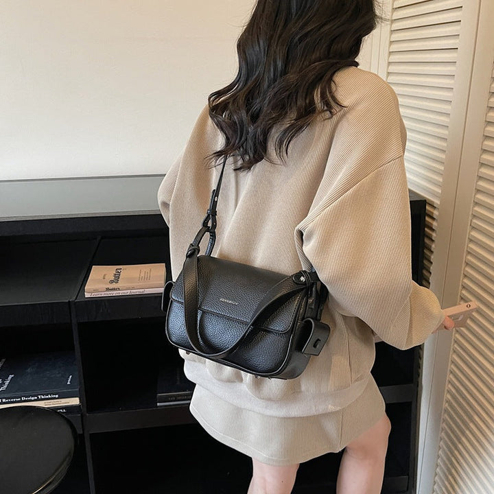 Women’s shoulder bag made of soft, textured leather with adjustable shoulder strap