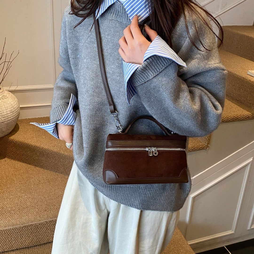 Women's shoulder bag made of soft suede leather with practical compartments