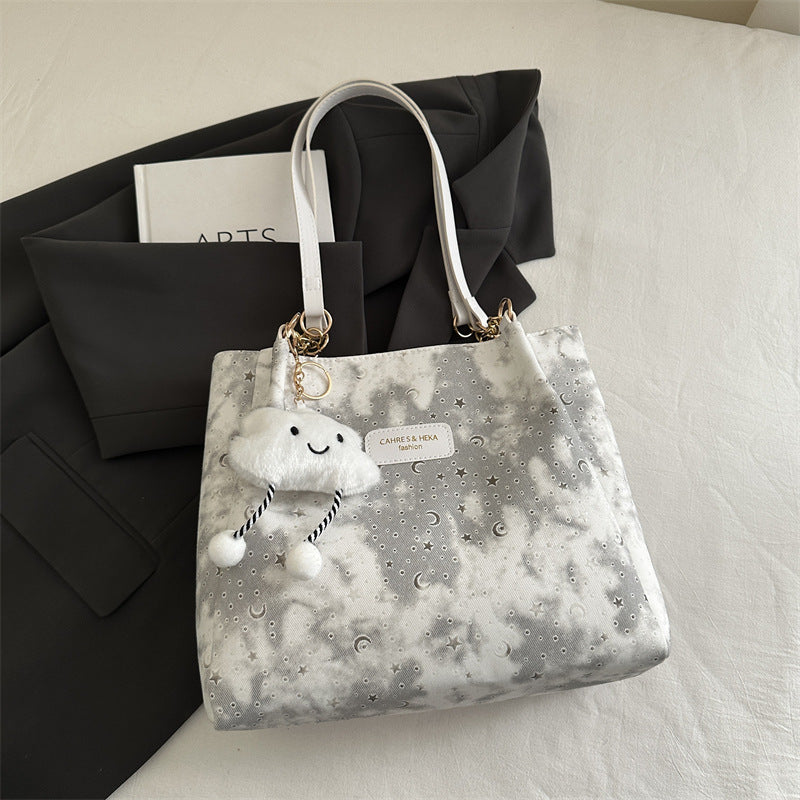 Women’s stylish tote bag with playful pendant