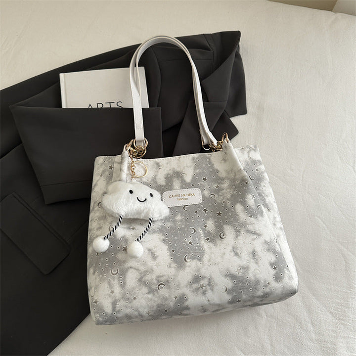 Women’s stylish tote bag with playful pendant