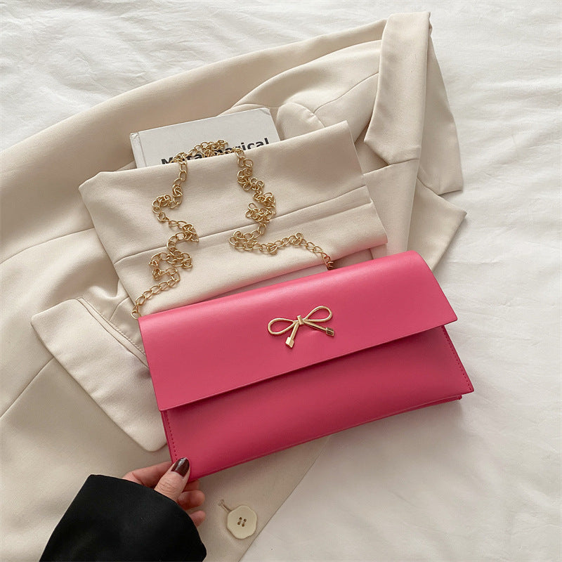 Women's elegant clutch in minimalist design with golden accents