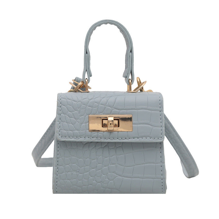 Ladies mini bag with elegant crocodile look and golden accents