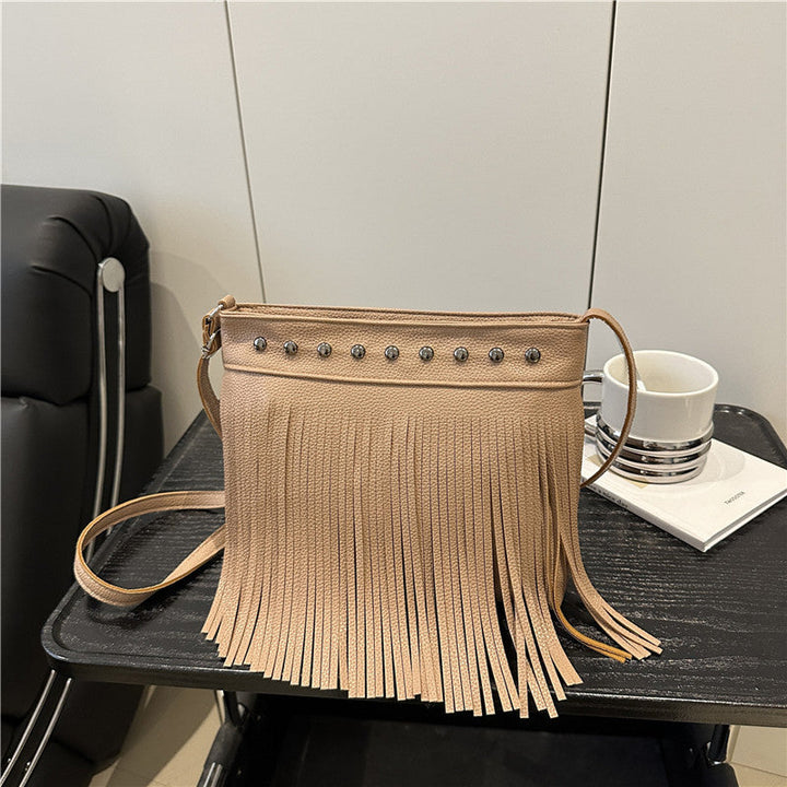 Ladies shoulder bag with fringes and studs