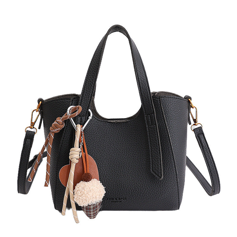 Women's mini handbag in an elegant design with charming pendant